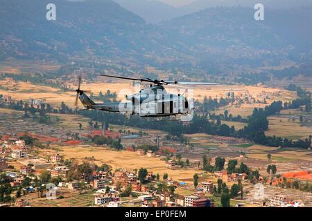 Kathmandu, Nepal. 10th May, 2015. A U.S. Marine Corps UH-1Y Venom from Joint Task Force 505 flies relief supplies following massive earthquakes that struck the mountain kingdom May 9, 2014 in Sindhuli District, Nepal. Stock Photo