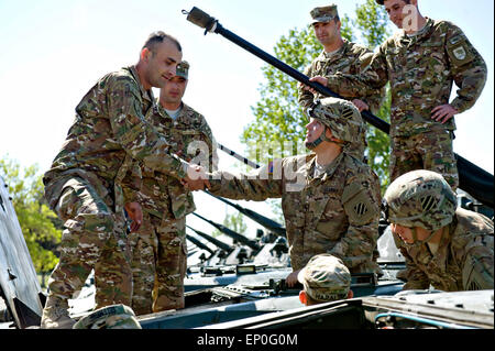 A Georgian soldier greets U.S. Army soldiers from the 3rd Infantry Division after arriving for exercise Noble Partner May 8, 2015 in Vaziani, Georgia. Noble Partner is a field training and live-fire exercise between the U.S. Army and the Georgian military. Stock Photo