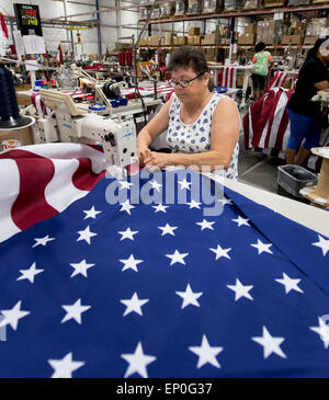 South Boston, Virginia, USA. 12th May, 2015. JOAN SNEAD sews the stripes to the star field of an American flag at Annin Flagmakers, the 160 year-old company whose flags have played an historic role in U.S. history. It was an Annin flag that was draped on Abraham Lincoln's casket and was later used in the funeral of John F. Kennedy. An Annin flag was raised atop Mt. Everest when the National Geographic Society summited it for the first time. An Annin flag was raised by Marines over Mt. Stock Photo