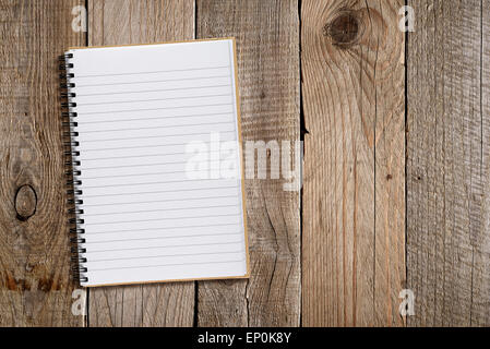 Lined notepad on old wooden background Stock Photo