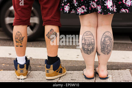 young couple in amsterdams old town with tattoos on their calves ep0w10