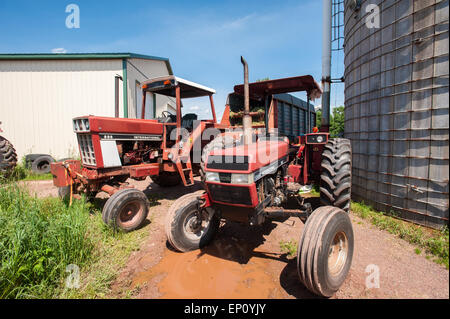 Two red tractors on farm in Honesdale, PA. Stock Photo