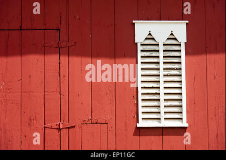 White wooden shutters on red barn in Westminster, Maryland, USA Stock Photo