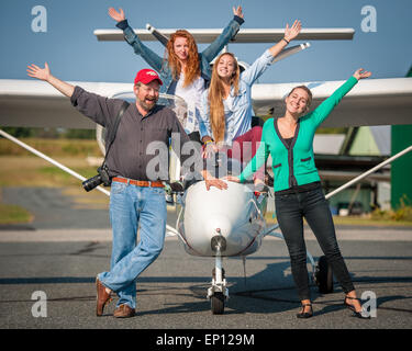 Small group of happy people surrounding, small airplane in Fallston, Maryland, USA Stock Photo
