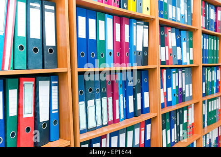 file folders, standing on the shelves in the background Stock Photo