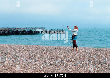 young woman taking a selfie with a tablet on southsea beach england uk Stock Photo