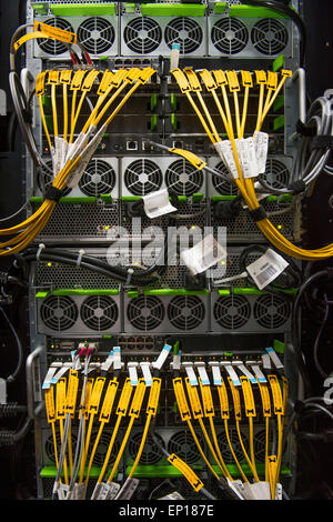 The rear of a computer server used for cloud computing showing routers and network cables. Stock Photo