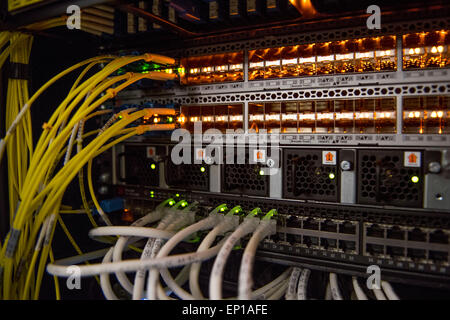The rear of a computer server used for cloud computing showing routers and network cables. Stock Photo