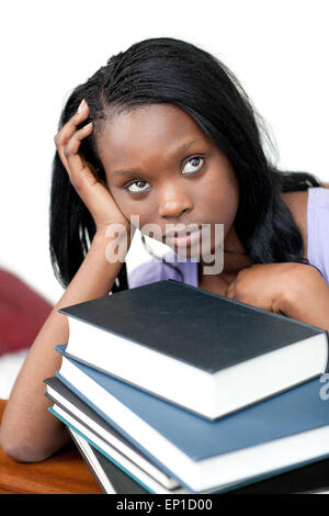 Upset student leaning on a stack of books Stock Photo - Alamy