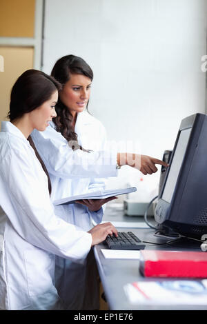 Portrait of focused scientist comparing results Stock Photo