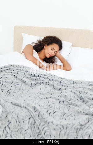Beautiful woman sleeping peacefully on her bed in the morning Stock Photo