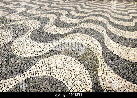 Wave patterns of traditional Portugese mosaic paving in Rossi Square, Lisbon, Portugal Stock Photo