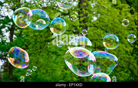 Multicolored big soap bubbles outdoors - natural background Stock Photo