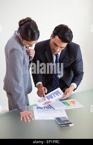 Portrait of focused sales persons studying statistics Stock Photo