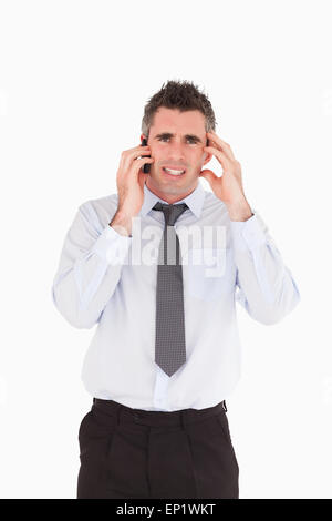 Portrait of an upset man making a phone call Stock Photo