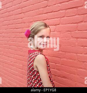Side view of a smiling girl with a flower in her hair Stock Photo