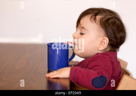 Boy drinking  water with straw Stock Photo