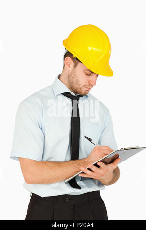 Young lead worker writing on his clipboard Stock Photo