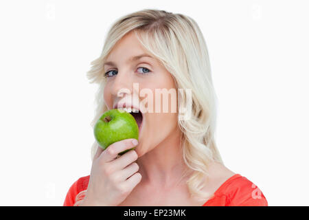 Attractive woman eating a delicious green apple Stock Photo