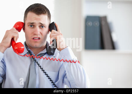 Close up of businessman unable to cope with the telephone Stock Photo