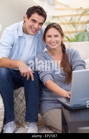 Portrait of a radiant couple using a notebook Stock Photo
