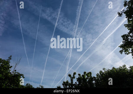 Multiple jet contrails in a vivid blue sky Stock Photo