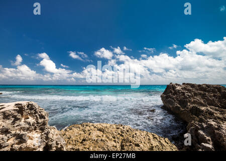 Ocean with waves and rocks on caribbean beach Stock Photo