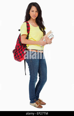 Beautiful Latin student with backpack holding textbooks Stock Photo