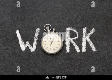 work word handwritten on chalkboard with vintage precise stopwatch used instead of O Stock Photo
