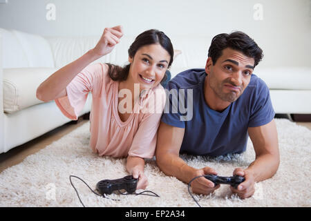 Woman beating her boyfriend while playing video games Stock Photo