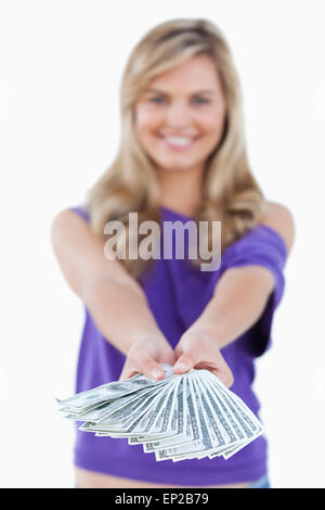 Fan of bank notes being held by a blonde woman Stock Photo