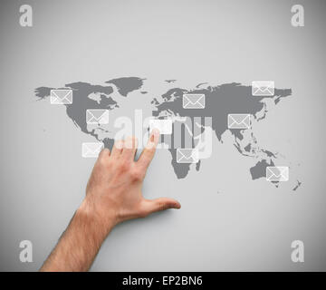Finger pointing at a message symbol against a map Stock Photo