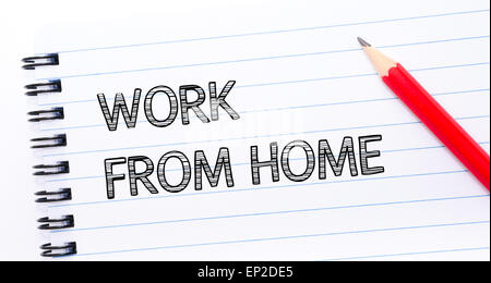WORK FROM HOME  written on notebook page, red pencil on the right. Concept image Stock Photo