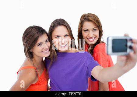 Three beautiful teenagers showing beaming smile in front of the camera Stock Photo
