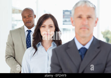 Young and serious businessman following two members of his team Stock Photo