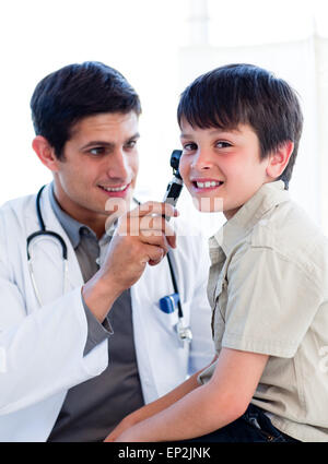 Charming doctor examining little boy's ears Stock Photo