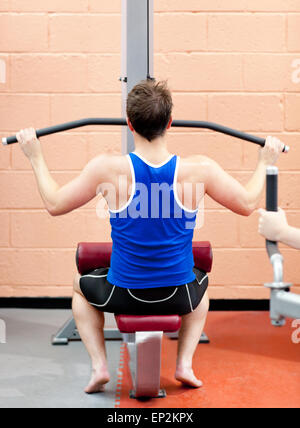 Assertive male athlete practicing body-building Stock Photo