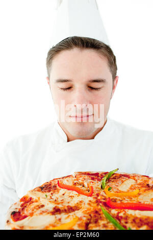 Young male cook smell at pizza with closed eyes Stock Photo