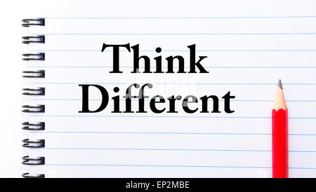 Think Different Text written on notebook page, red pencil on the right. Motivational Concept image Stock Photo
