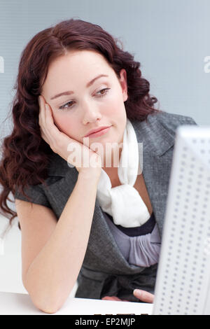 Young businesswoman in office getting bored Stock Photo