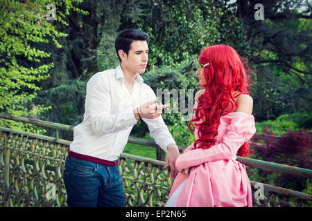 Romantic Fairy Tale Couple on a Balcony in Peaceful Idyllic Setting, Prince and Princess Gazing at Each Other Stock Photo