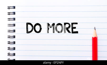 Do More Text written on notebook page, red pencil on the right. Motivational Concept image Stock Photo