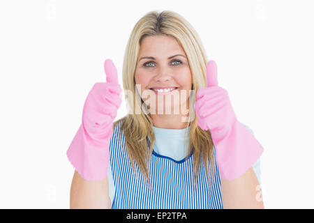 Cheerful cleaner putting thumbs up with pink gloves Stock Photo