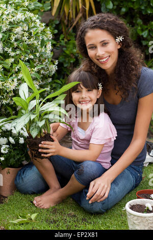Mother and daughter working in the garden Stock Photo