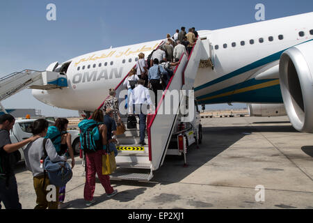 Passengers boarding Oman Airways plane, Seeb International Airport, Muscat, Oman Stock Photo