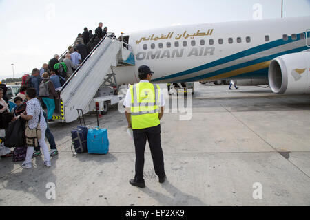 Passengers boarding Oman Airways plane, Seeb International Airport, Muscat, Oman Stock Photo