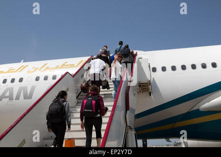 Passengers boarding Oman Airways plane, Seeb International Airport, Muscat, Oman Stock Photo