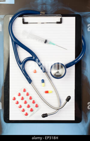 Note pad and blister strip with medicine and blue stethoscope Stock Photo