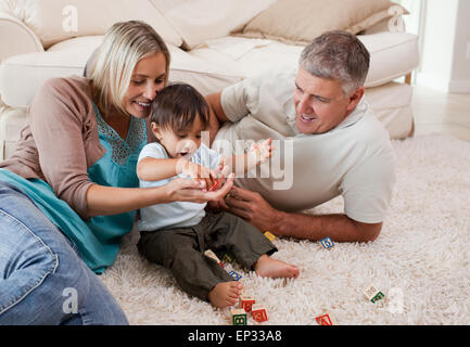 Son playing with his parents Stock Photo