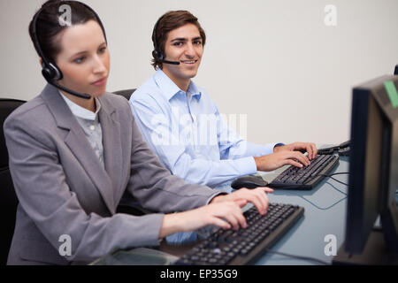 Side view of call center agents working in their office Stock Photo